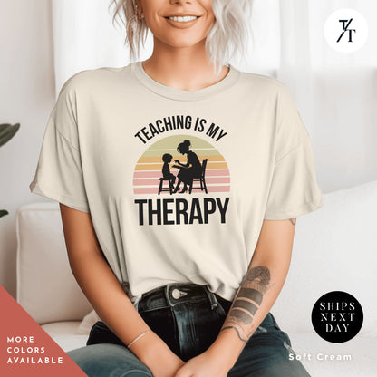 a woman wearing a teaching is my therapy t - shirt