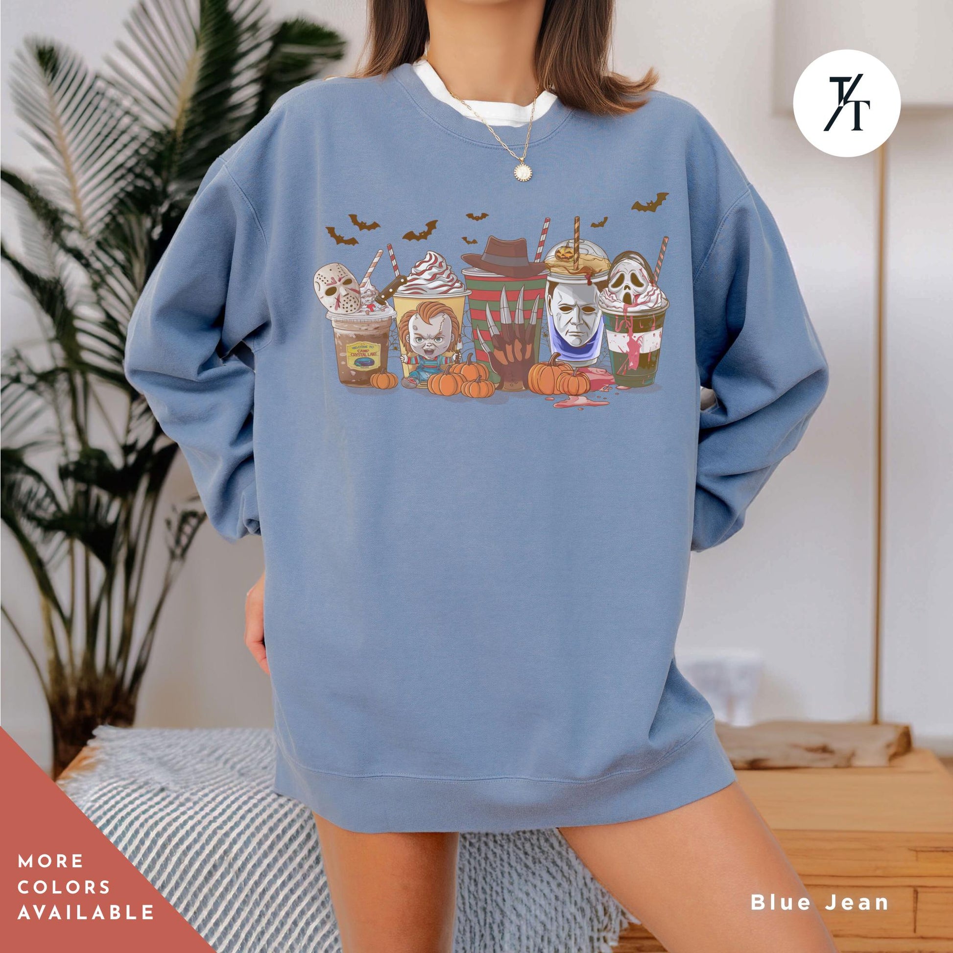 a woman wearing a blue sweatshirt with a picture of a group of cats on it
