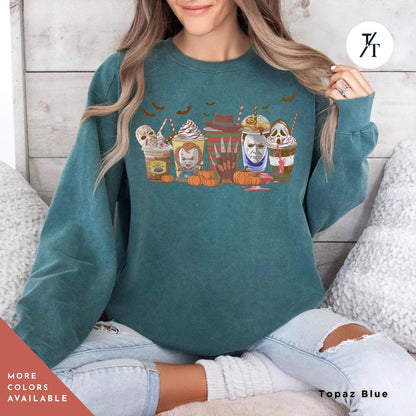 a woman wearing a green sweatshirt with a picture of group of halloween horror characters on coffee drinks on it,  Skeleton Coffee Cups Sweatshirt, Coffee Cups Sweatshirt, Skull Coffee Cup Sweatshirt, Skeleton Halloween Sweatshirt,