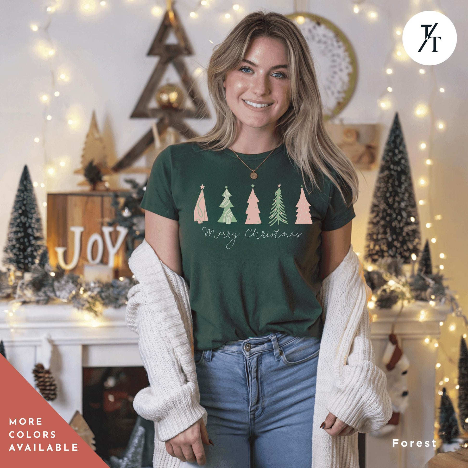 a woman standing in front of a christmas tree t - shirt
