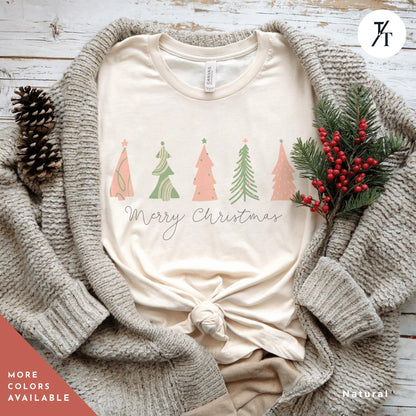 a shirt with 4 pink Christmas trees that says &quot;Merry Christmas&quot; North Pole Christmas Tree Farm Shirt, Coquette Pink Christmas Tree Shirt, Xmas Gift, Farm Fresh Xmas Shirt, Women Holiday Tee