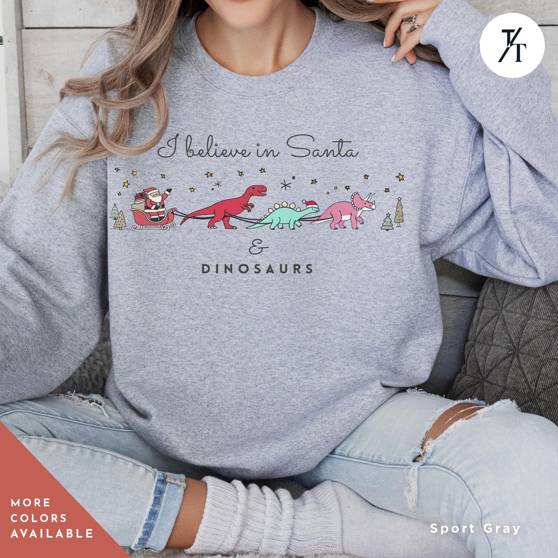 a woman wearing a sweatshirt that says believe in santa and dinosaurs, I believe in santa and dinosaurs sweatshirt, Christmas Sweatshirt, I Believe In Santa Dinosaurs Sweatshirts, Christmas Gifts Holiday Sweater