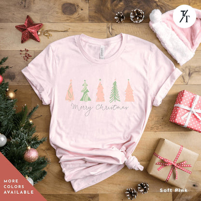 a shirt with 4 pink Christmas trees that says &quot;Merry Christmas&quot; North Pole Christmas Tree Farm Shirt, Coquette Pink Christmas Tree Shirt, Xmas Gift, Farm Fresh Xmas Shirt, Women Holiday Tee