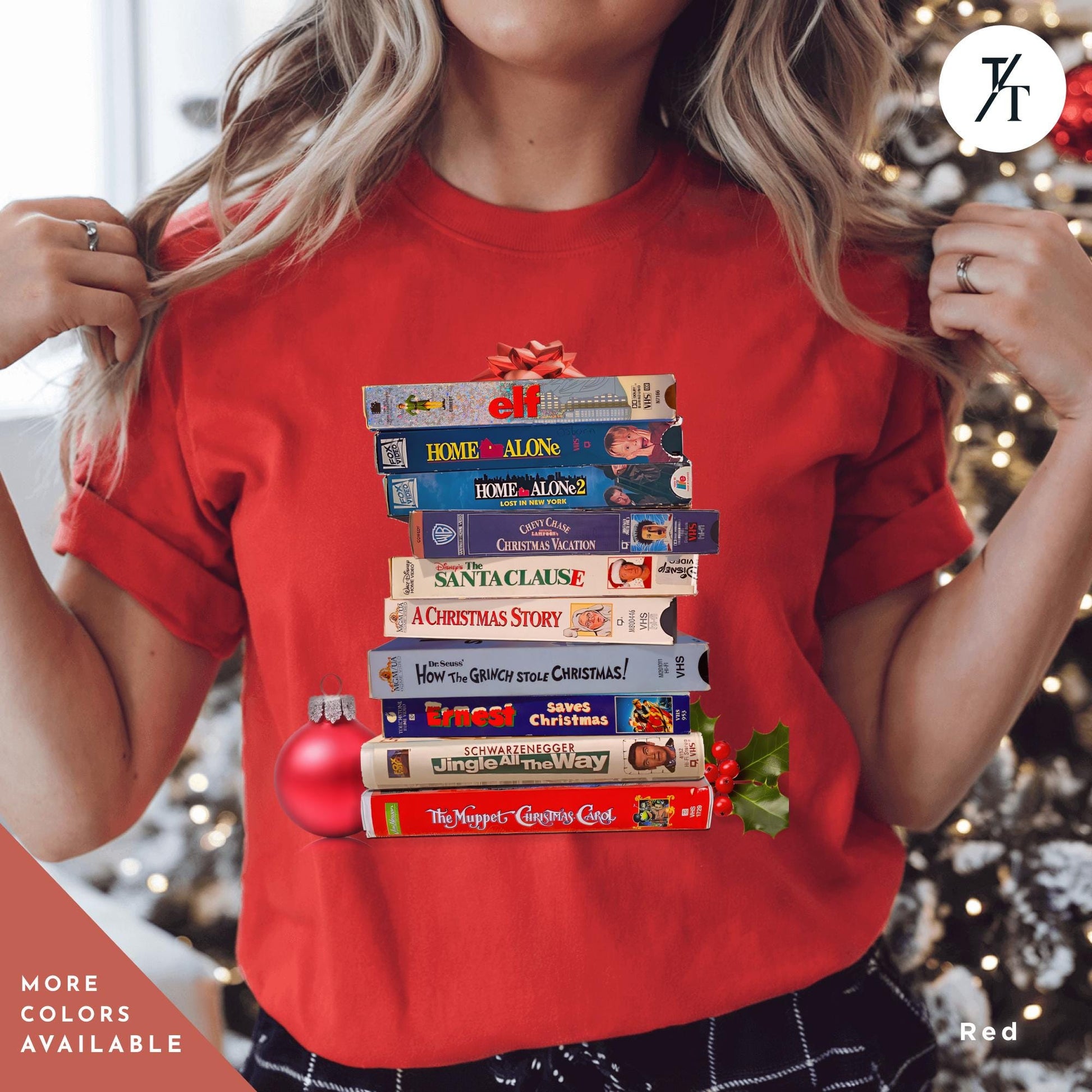 a woman holding wearing a red shirt with stack of vhs tapes on top of each other,  Vintage Christmas Movies Vhs Shirt Christmas Crewneck, Retro VHS Xmas Tapes Gift For Her, Family Reunion Shirt, 1990s Holiday Sweatshirt