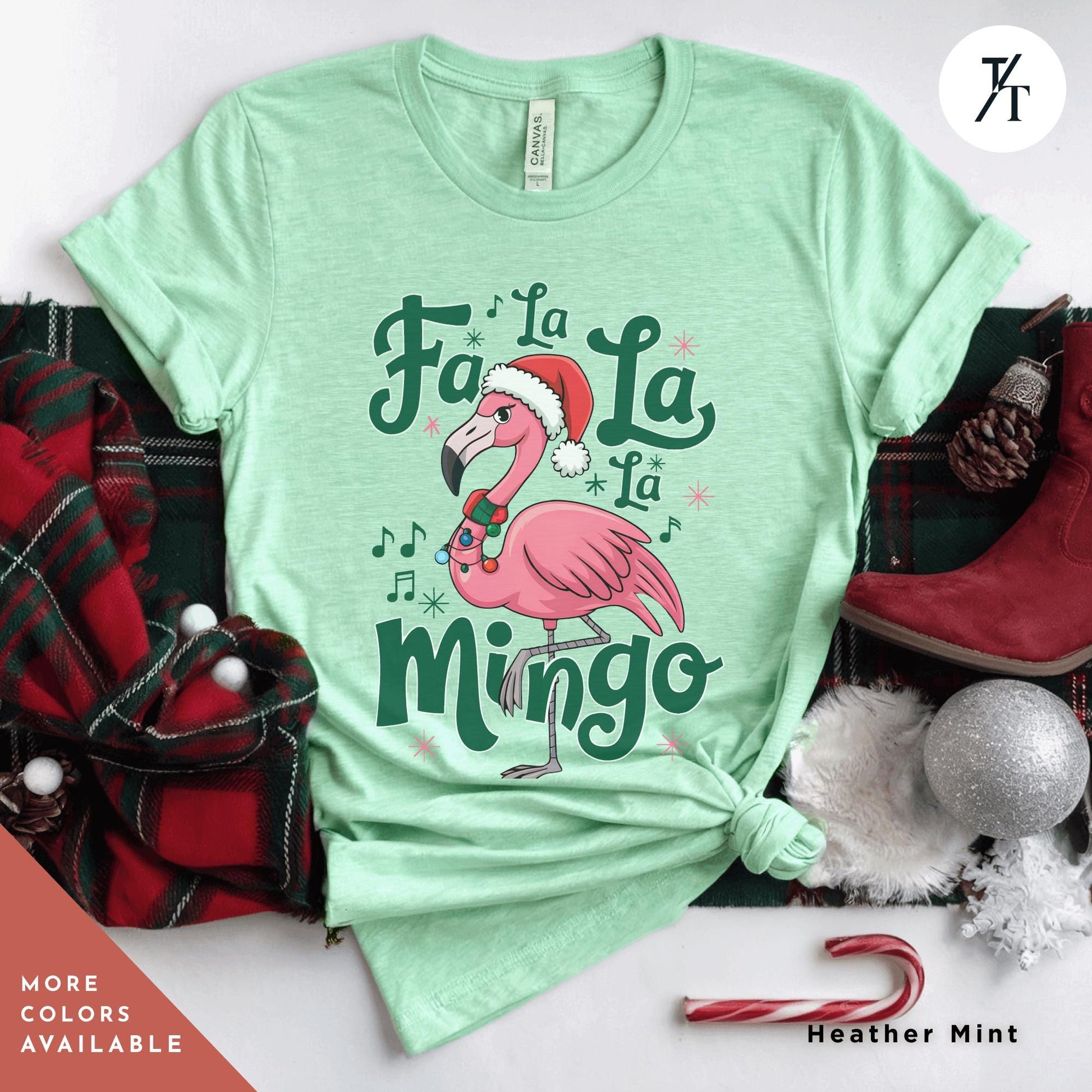 a green shirt with a pink flamingo wearing a santa hat