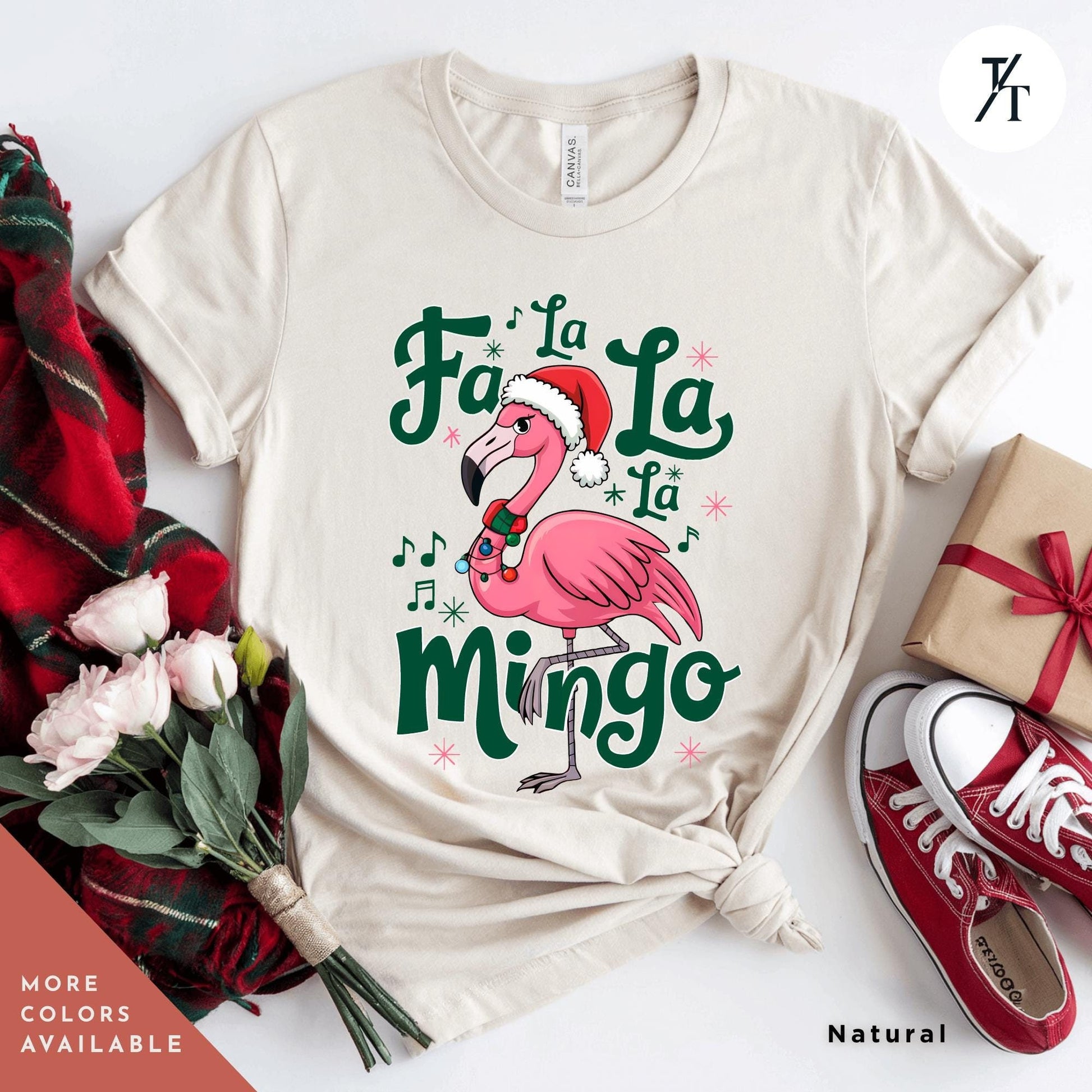 a white shirt with a pink flamingo wearing a santa hat