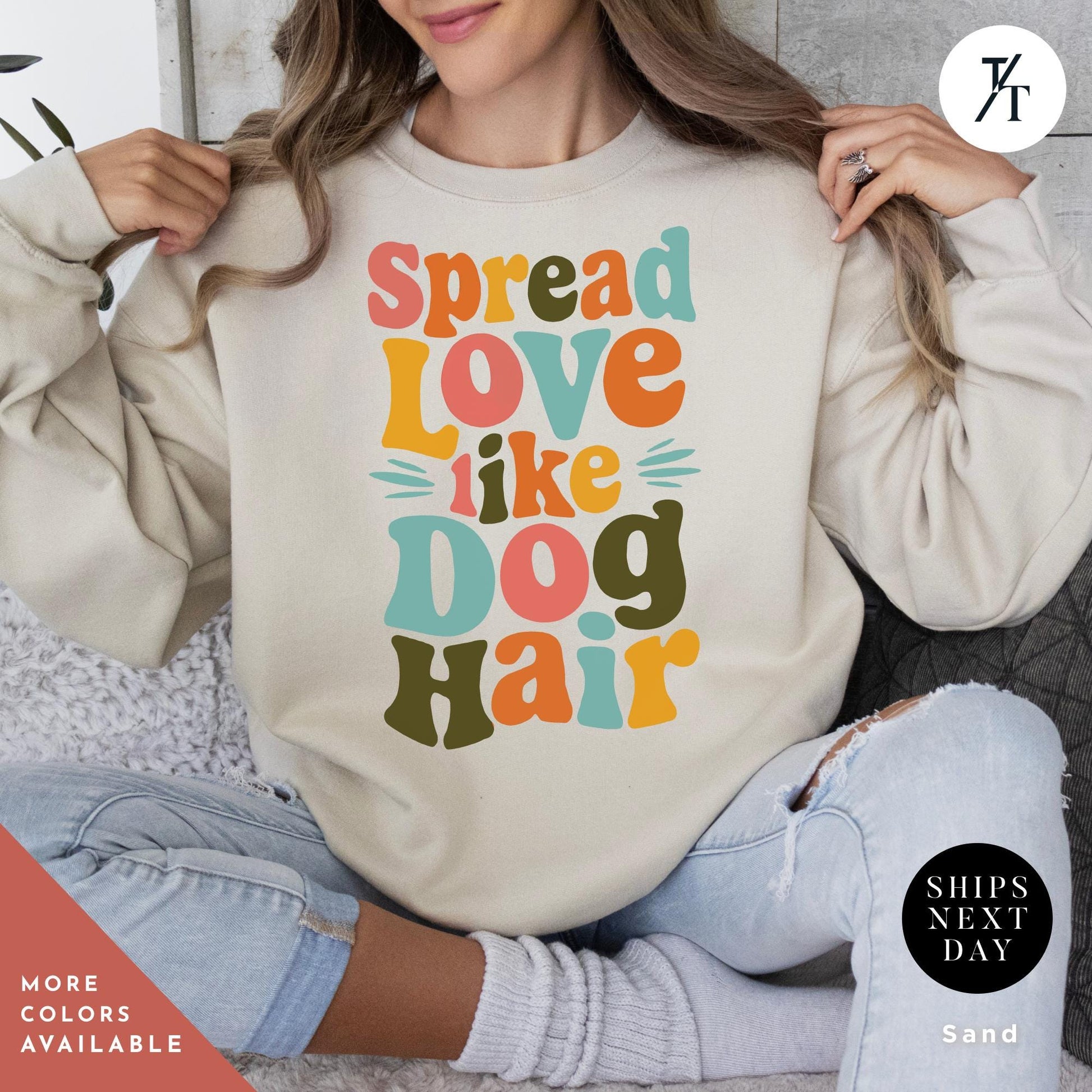 a woman wearing a sweatshirt that says spread love like a dog hair