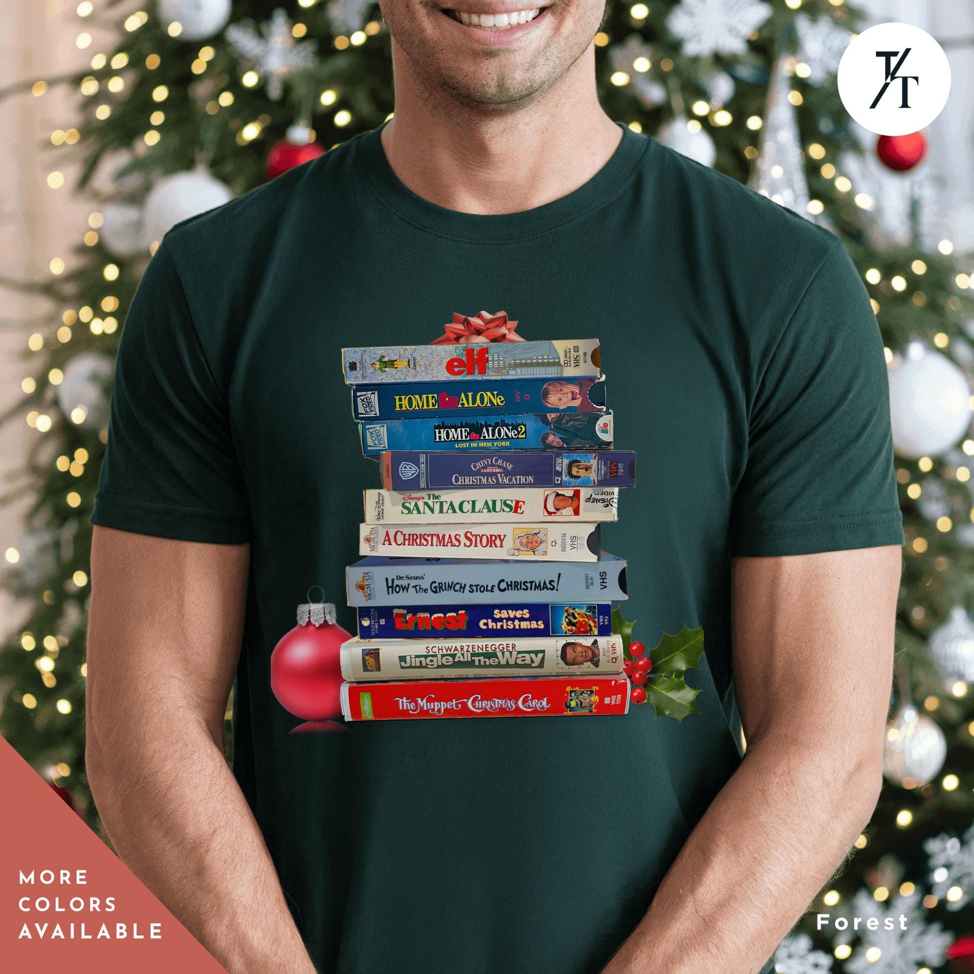 a man wearing a green shirt  with stack of vhs tapes on top of each other,  Vintage Christmas Movies Vhs Shirt Christmas Crewneck, Retro VHS Xmas Tapes Gift For Her, Family Reunion Shirt, 1990s Holiday Sweatshirt