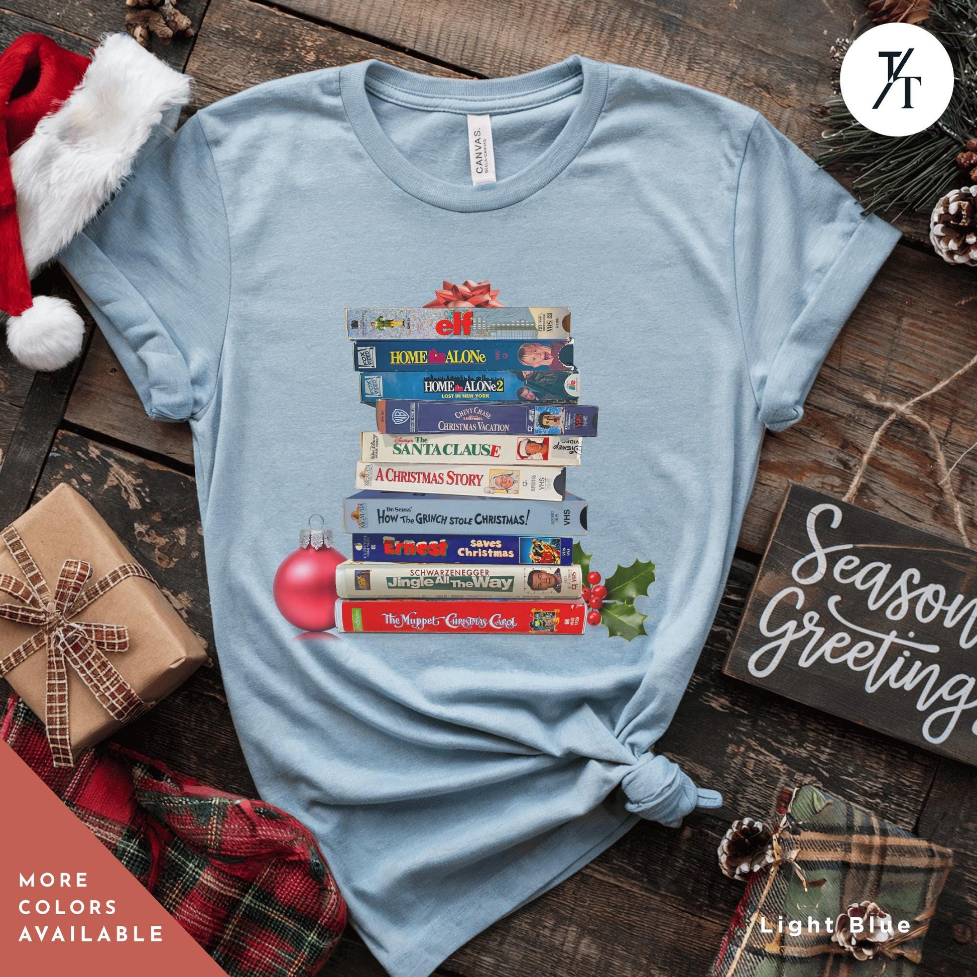 a blue shirt  with stack of vhs tapes on top of each other,  Vintage Christmas Movies Vhs Shirt Christmas Crewneck, Retro VHS Xmas Tapes Gift For Her, Family Reunion Shirt, 1990s Holiday Sweatshirt