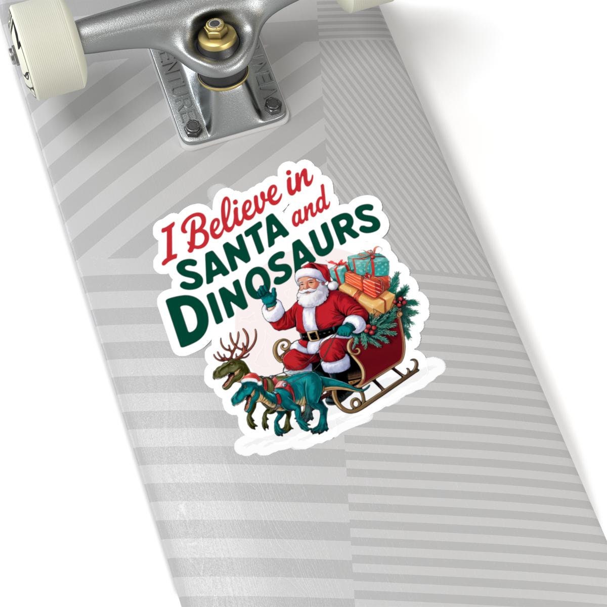 a skateboard with a sticker of santa claus riding a sleigh, I believe in santa and dinosaurs christmas dinosaur decal, Dinosaur Christmas Vinyl Decal Xmas Sticker Dino Reindeers Xmas Stocking Stuffer