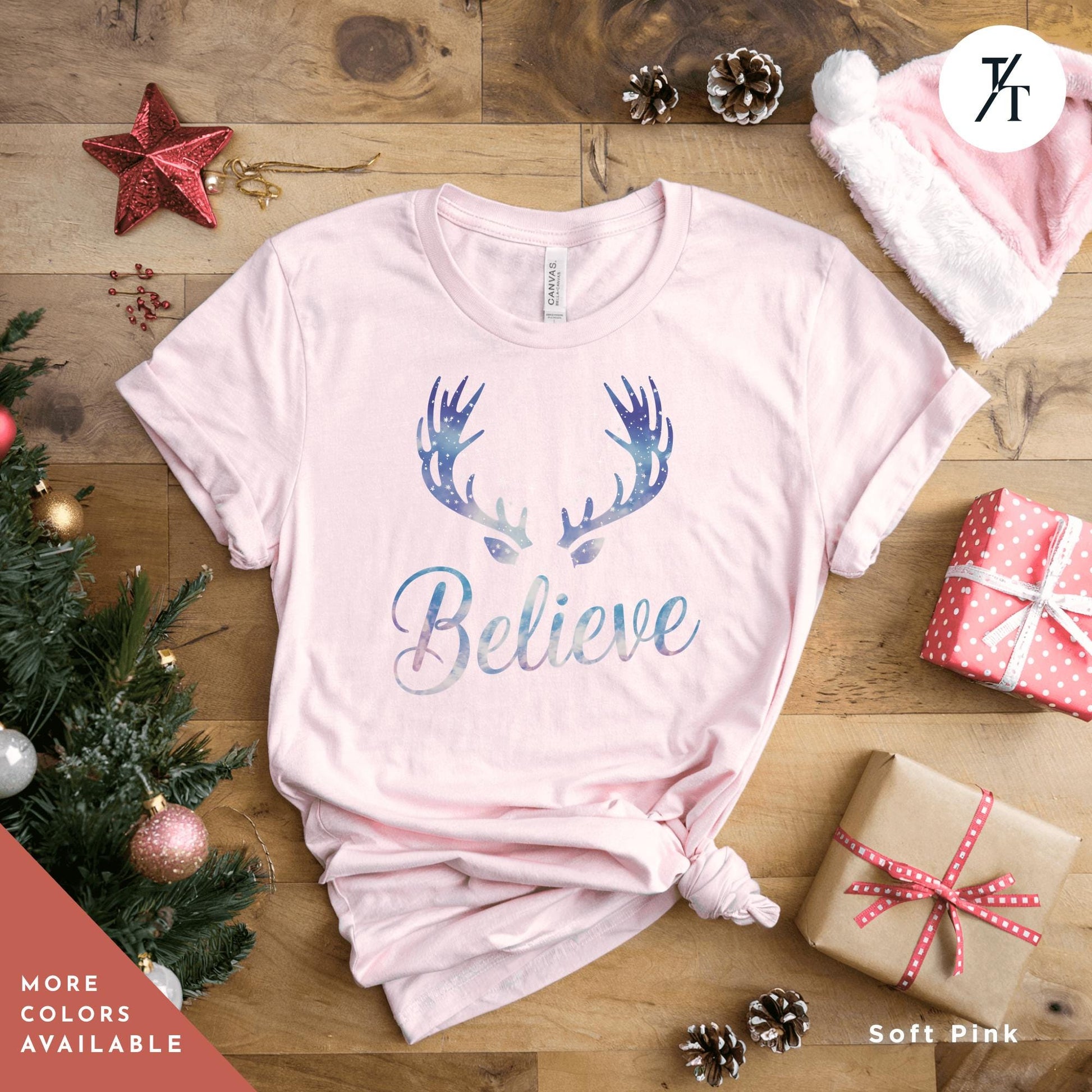 a pink t - shirt with a deer&#39;s antlers on it Believe in Miracles Santa Shirt, Christmas Miracle Reindeer Shirt, Merry Christmas Tee, Believer Tee, Santa Believe Shirts Believe Quote