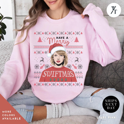 a woman wearing a pink sweater with a picture of a woman wearing a santa hat