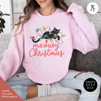 a woman sitting on a couch wearing a pink christmas sweatshirt, Meowy Christmas Sweater - Catmas Sweatshirt, Meowy Christmas Sweatshirt, Gift For Cat Mom, Cute Cat Mom Sweatshirts, Holiday Sweatshirts