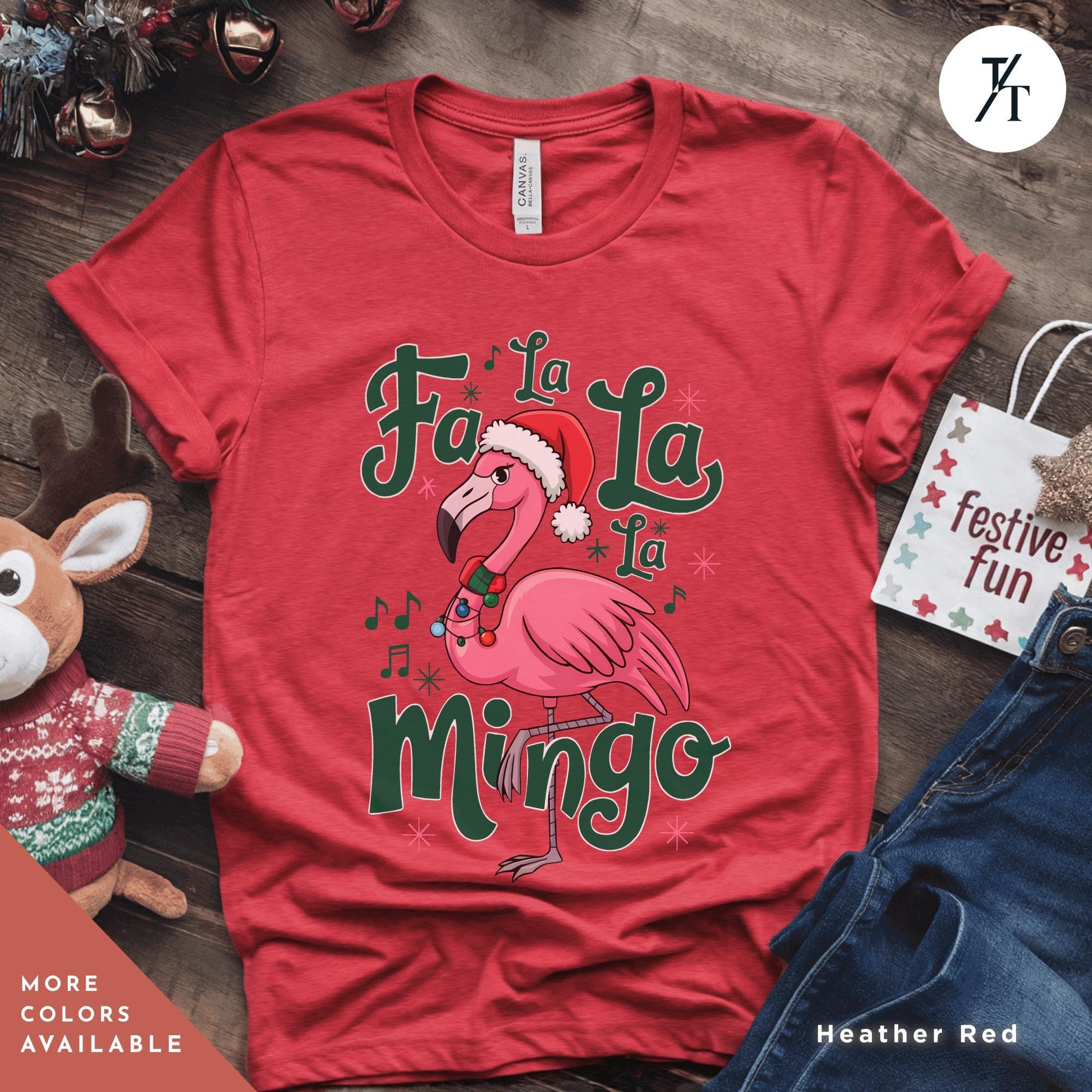 a pink flamingo wearing a santa hat and holding a candy cane
