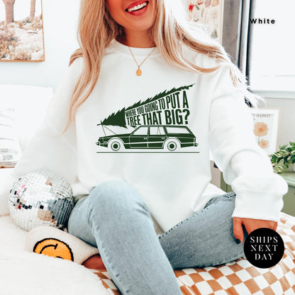 a woman sitting on a bed wearing a white sweatshirt, You&#39;Re Gonna Put A Tree That Big Unisex Sweatshirts, Funny Christmas Gift, Griswold Sweatshirt, Christmas Sweatshirts for Christmas Vacation