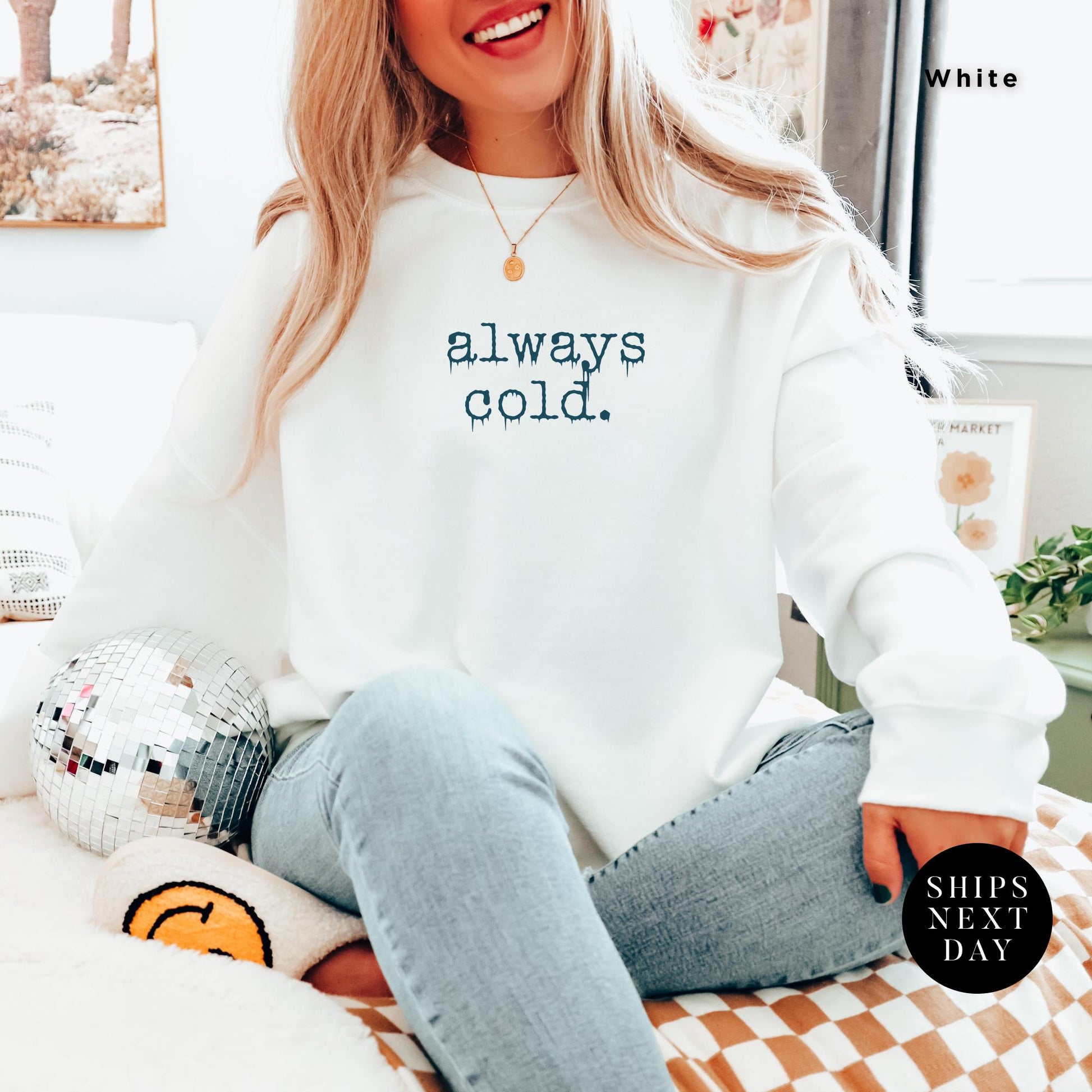 a woman sitting on top of a bed wearing a white sweatshirt, Always Cold Sweatshirt, Funny Cold Winter Sweatshirt, womens winter gift, cute fall gift, christmas gift, winter graphic Holiday Sweatshirt