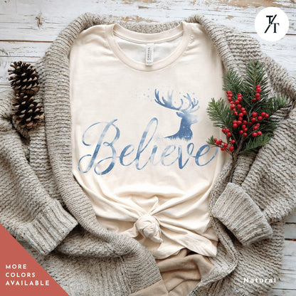 a t - shirt with the words believe on it Believe in Miracles Santa Shirt, Christmas Miracle Reindeer Shirt, Merry Christmas Tee, Believer Tee, Santa Believe Shirts Believe Quote