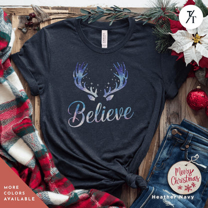 a t - shirt that says believe with a deer&#39;s antlers on it Believe in Miracles Santa Shirt, Christmas Miracle Reindeer Shirt, Merry Christmas Tee, Believer Tee, Santa Believe Shirts Believe Quote