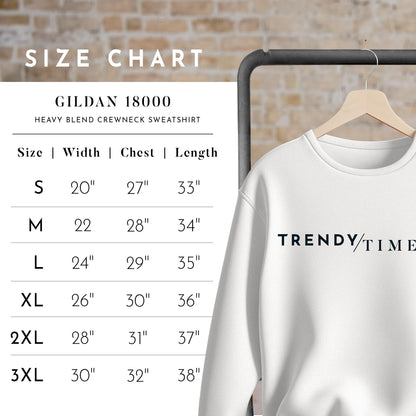 a white sweatshirt hanging on a rack next to a brick wall