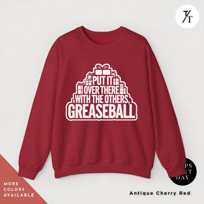 a red sweatshirt that says put it over there with the others greaseball