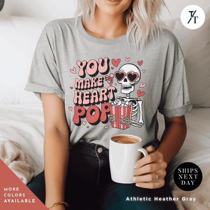 Woman wearing a shirt with a skeleton holding popcorn that says You Make My Heart Pop, Shirt Funny Skeleton Valentines Gift For Her, Retro Valentines Day Skeleton shirt, Heart Pops For You Valentine tee