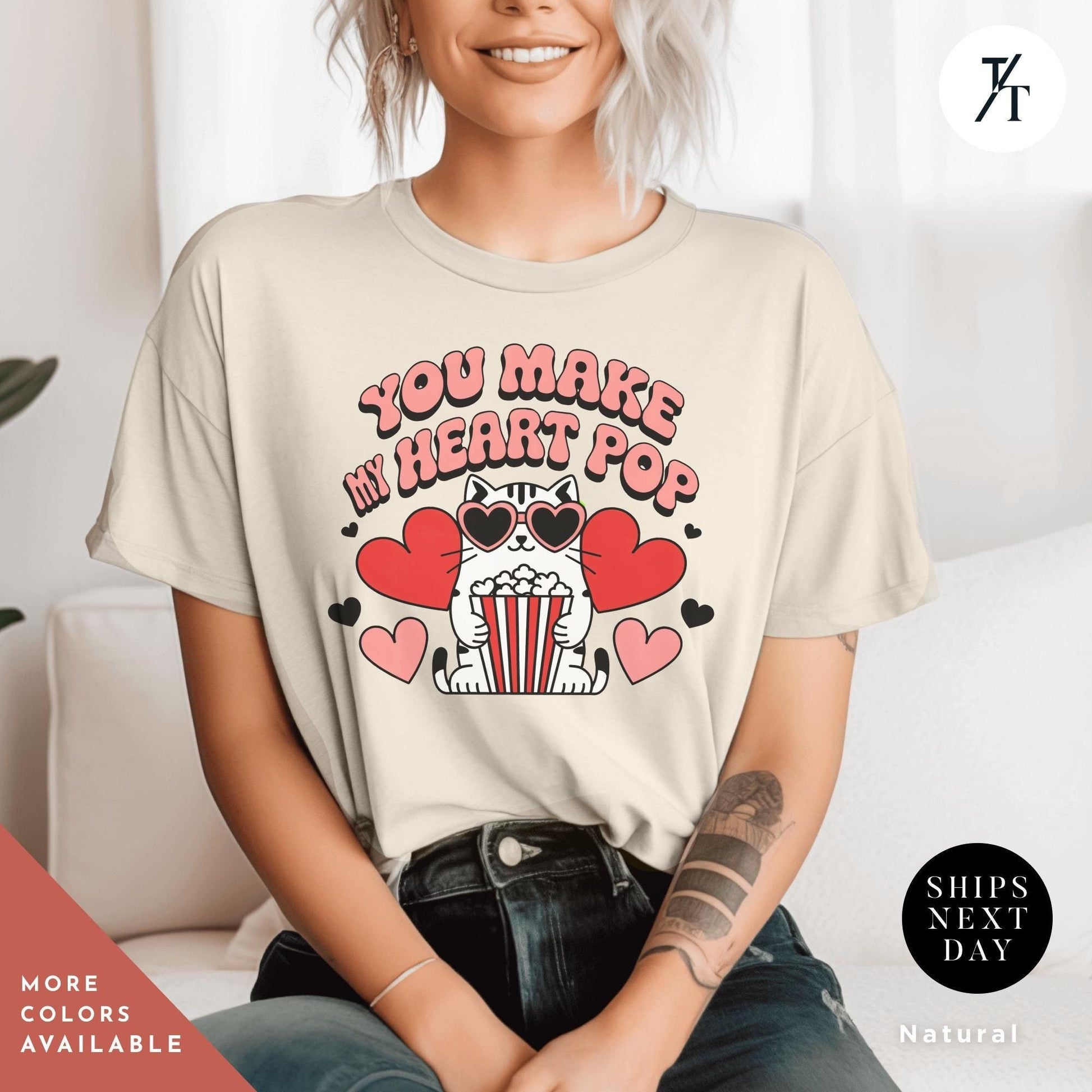 a woman sitting on a couch wearing a t - shirt with the words You Make My Heart Pop Shirt, Valentine Cat Shirt, Retro Valentines Day Shirts, Funny Valentine Tee, Cute Popcorn Valentines Gift for Her